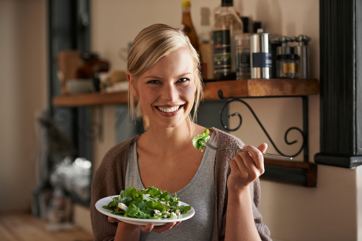 Lady smiling with salad